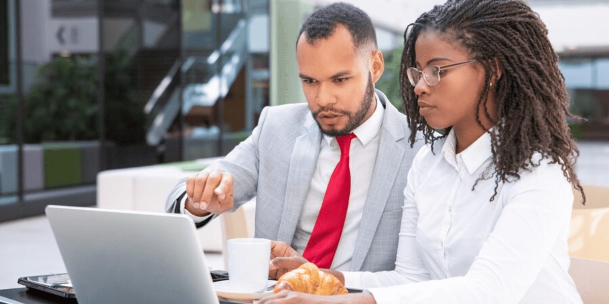 two professionals looking at laptop screen