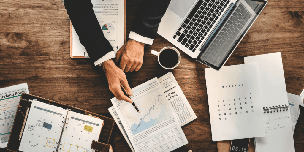 man pointing at graph on paper