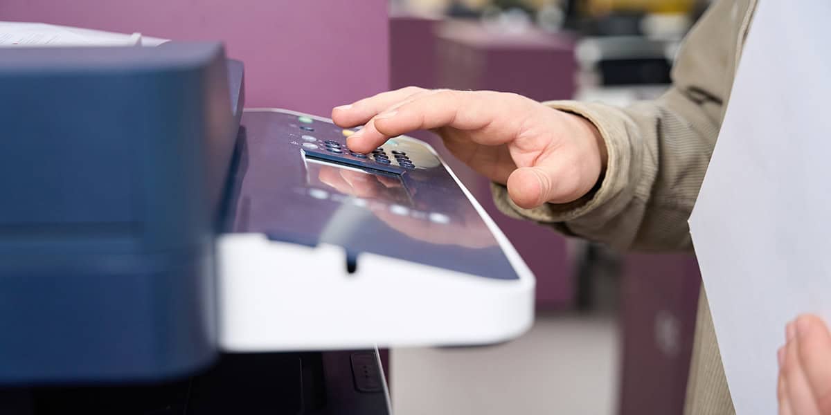 Caucasian male office worker using photocopy machine