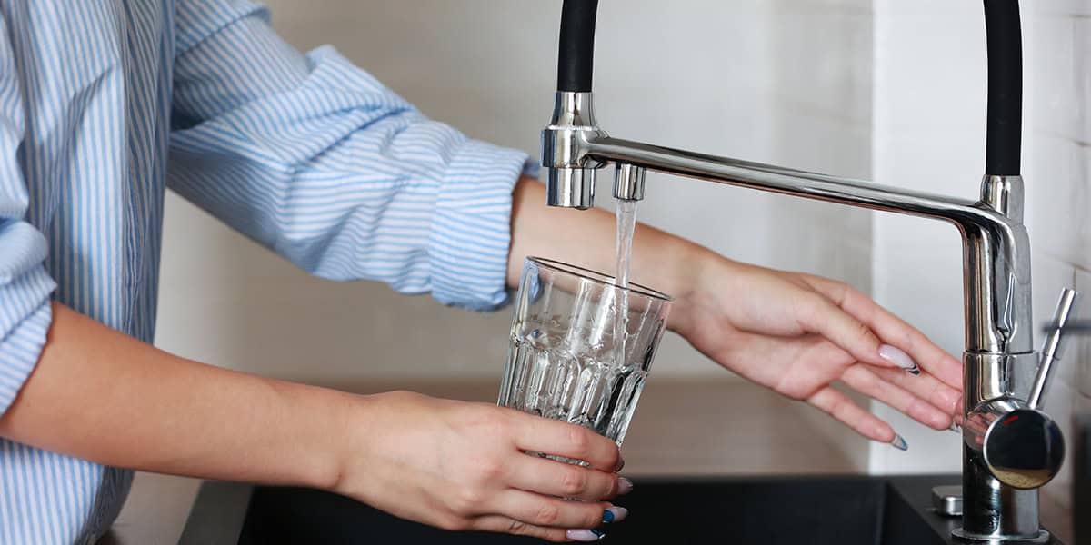 Filling glass of water from sink