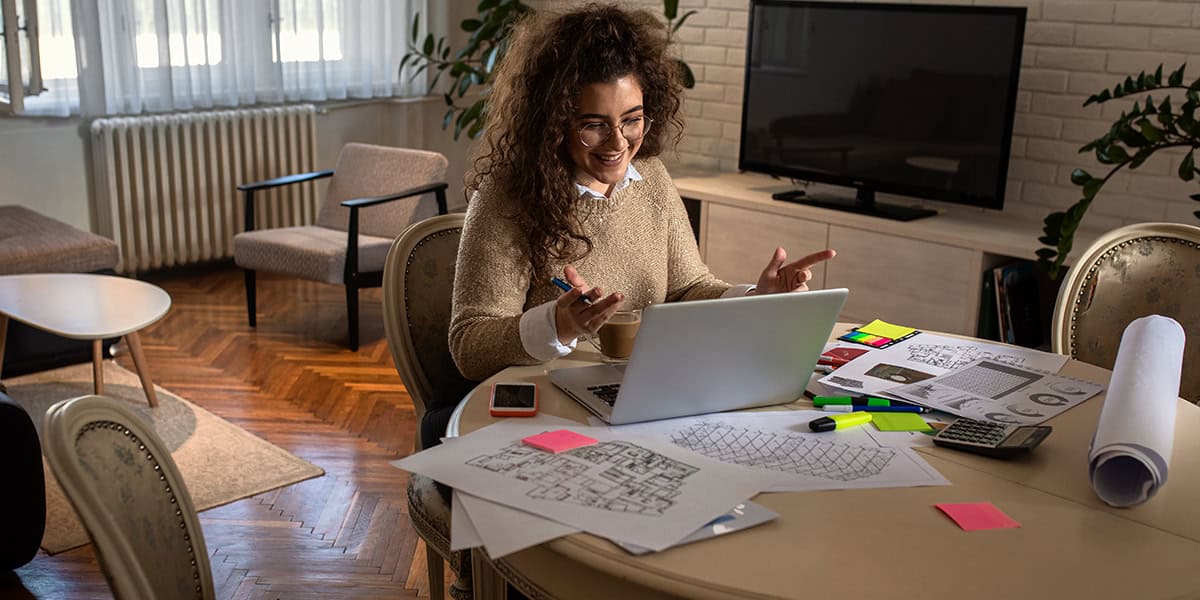 Young woman working from home in her living room.