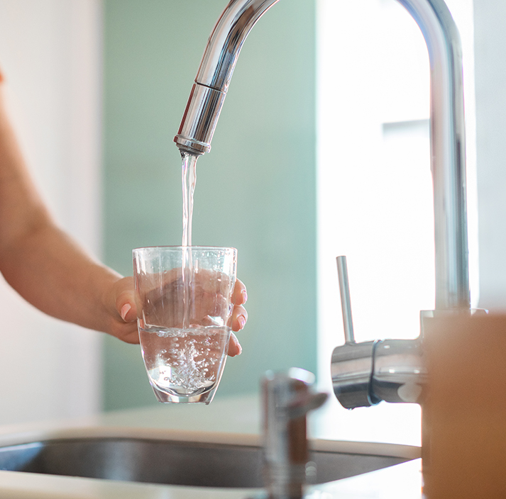 Filling glass of water from sink